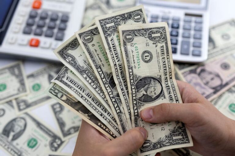 US dollar edges lower as traders await Fed rate cut decision