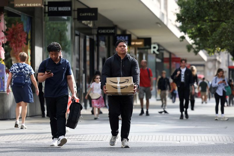 UK shop prices fall faster but retailers warn of risks in budget