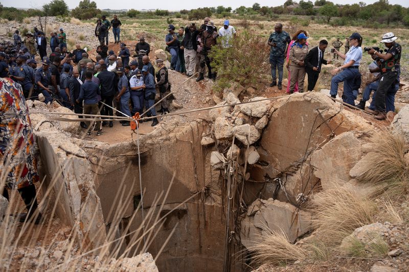 Families gather at South African mine shaft where hundreds are feared stuck underground