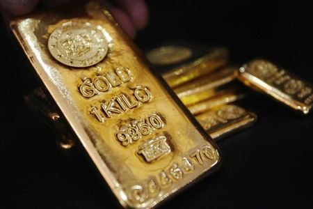 Gold prices climb, but dollar gains keep lid on upside after stronger Nov. payroll